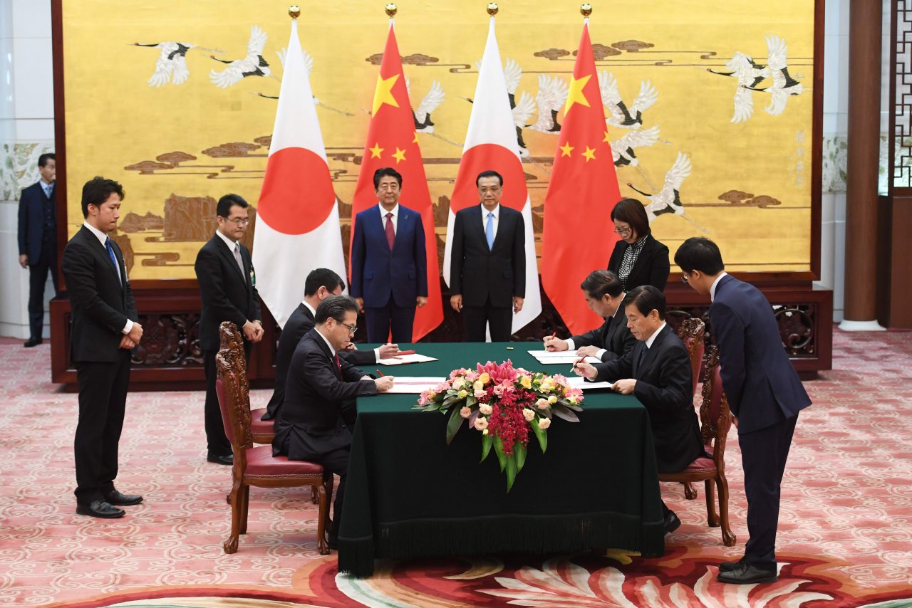 Japan, China strike deals during Abe visit as ties improve