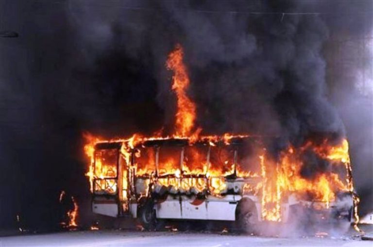 Unidentified group torches bus