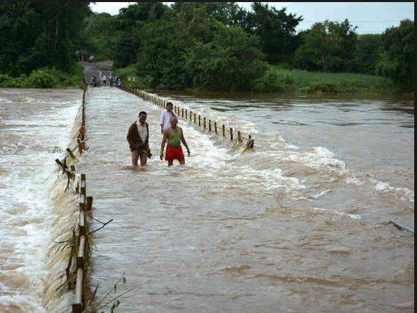 Two swept away by flooded river