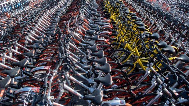 Beijing bans new bikes as sharing schemes cause chaos